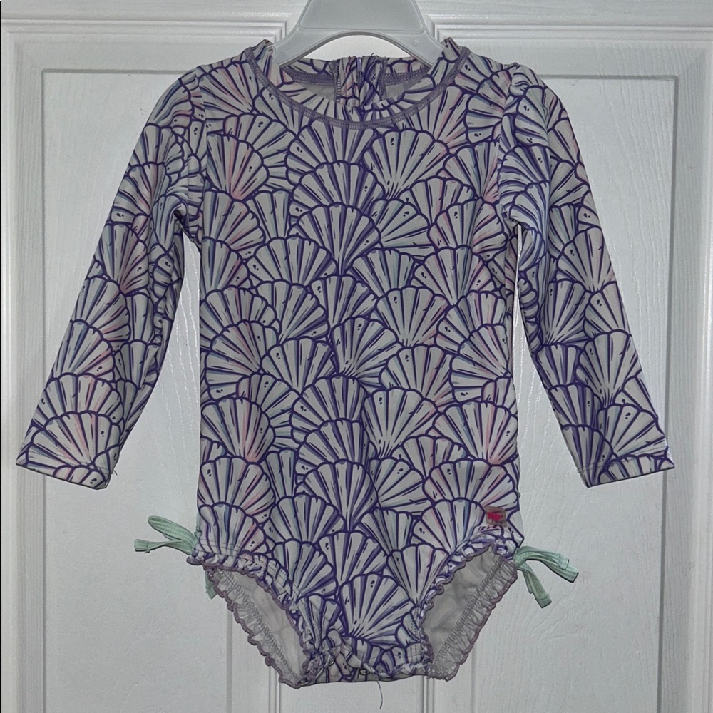 Rufflebutts Toddler Purple Shell Pattern Swimsuit. Mermaid themed.